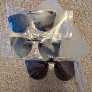 A set of three clip on sunglasses